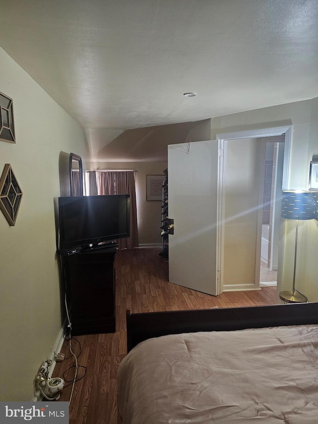 bedroom with dark wood-type flooring