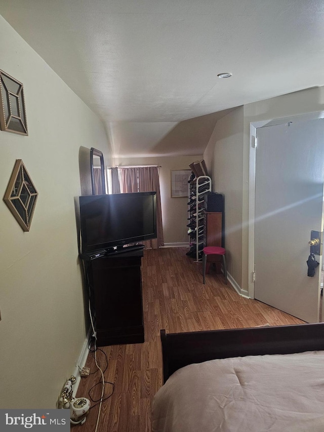 bedroom with dark hardwood / wood-style floors