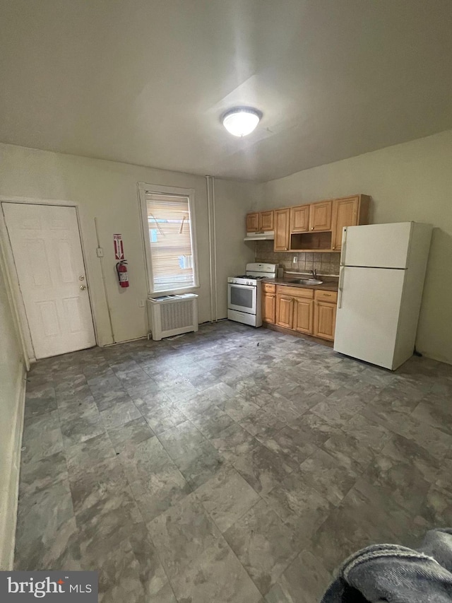 kitchen with backsplash, sink, white appliances, and radiator heating unit