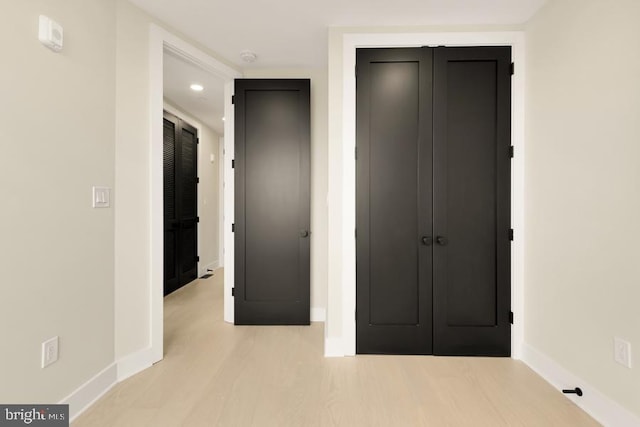 unfurnished bedroom with light wood-type flooring and a closet