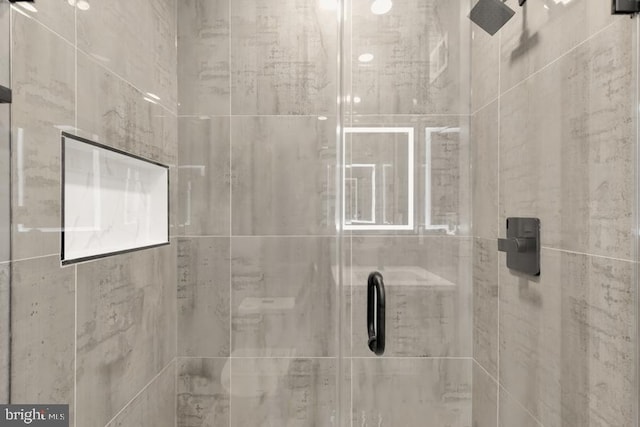 bathroom with tiled shower