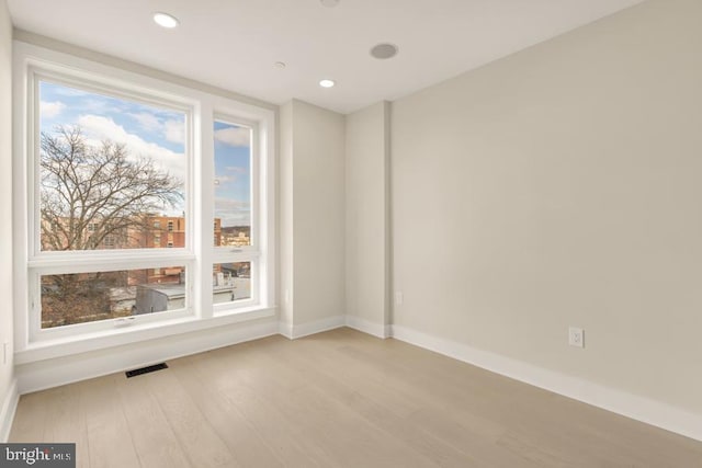 unfurnished room with light hardwood / wood-style flooring