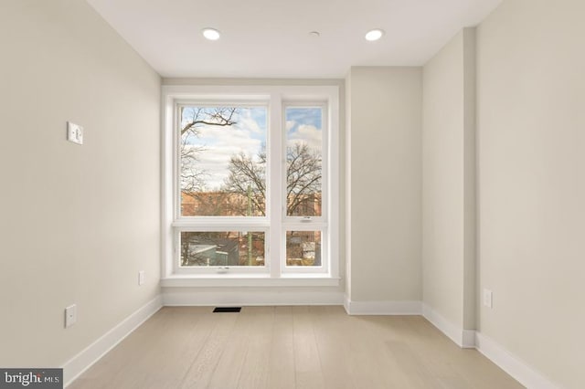 empty room with light hardwood / wood-style flooring