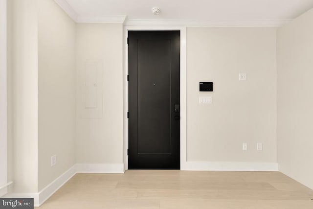 spare room featuring light hardwood / wood-style floors and ornamental molding