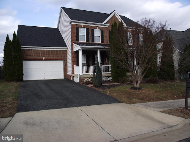 view of front of house featuring covered porch and a garage