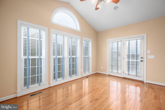 empty room with light hardwood / wood-style floors and a wealth of natural light