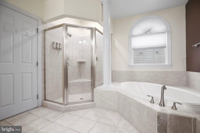 bathroom featuring separate shower and tub, tile patterned flooring, and decorative columns