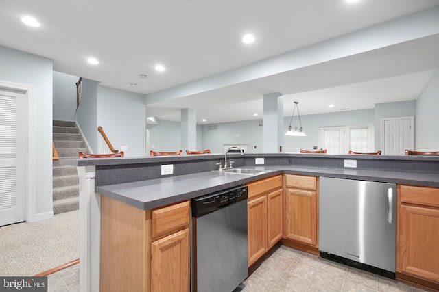 kitchen with dishwasher, sink, hanging light fixtures, fridge, and light carpet