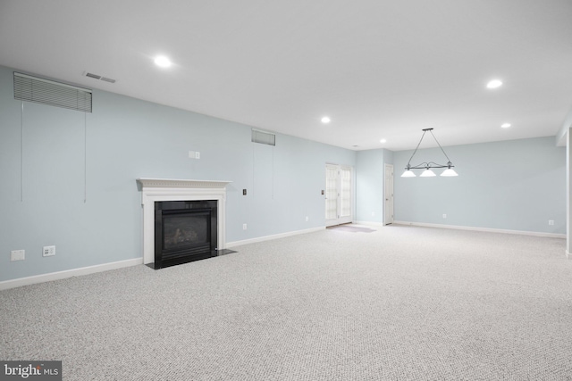 unfurnished living room with light colored carpet