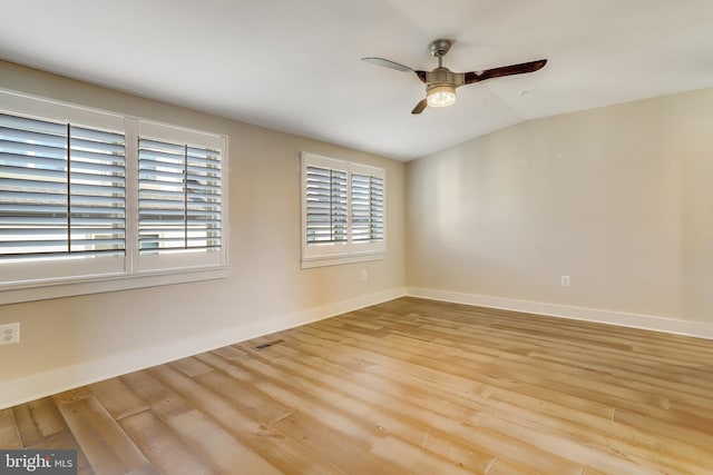 empty room featuring ceiling fan, lofted ceiling, and light wood-type flooring