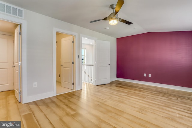 unfurnished bedroom featuring light hardwood / wood-style floors, vaulted ceiling, and ceiling fan