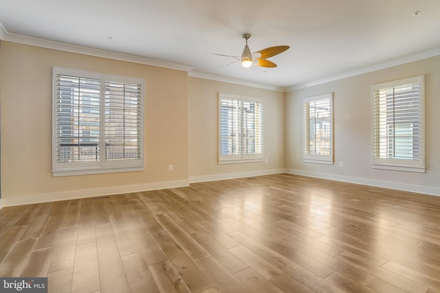 empty room featuring ceiling fan, ornamental molding, and light wood-type flooring