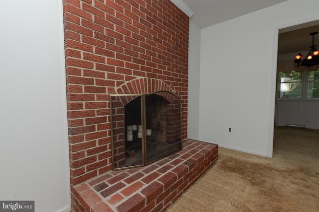 325 Great Oak Dr, Middletown, DE 19709 - detailed view of carpet, a chandelier, baseboards, and a brick fireplace