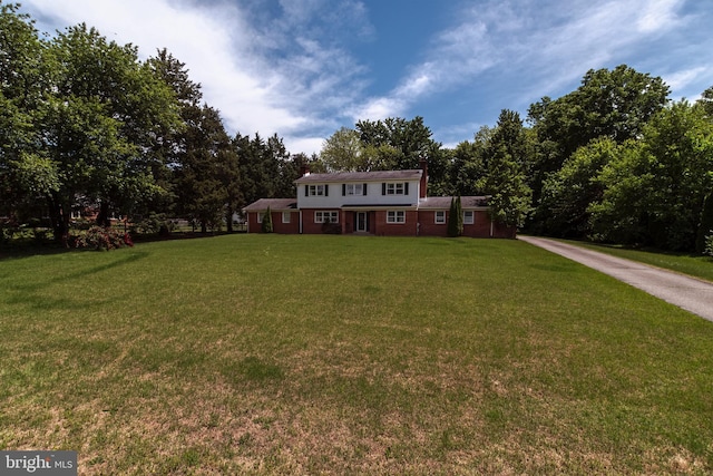 325 Great Oak Dr, Middletown, DE 19709 - colonial home featuring a front lawn and a chimney