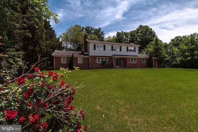 325 Great Oak Dr, Middletown, DE 19709 - view of front facade with a chimney, a front lawn, and brick siding