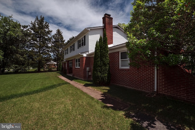 325 Great Oak Dr, Middletown, DE 19709 - view of side of home with a lawn, a chimney, and brick siding