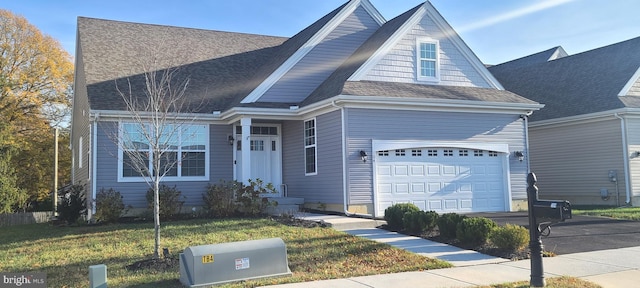 view of front facade featuring a garage and a front lawn