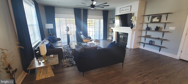 living room featuring dark hardwood / wood-style flooring, plenty of natural light, and ceiling fan