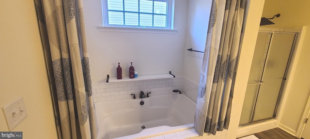 bathroom featuring hardwood / wood-style floors and shower with separate bathtub