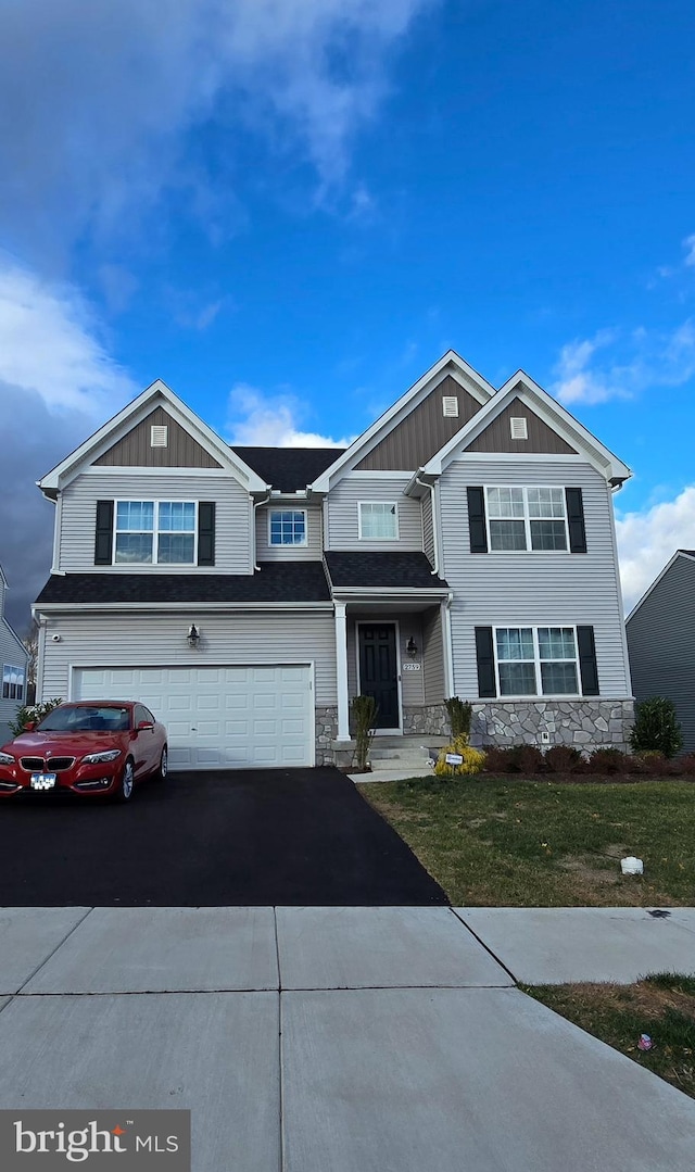 view of front of house with a garage and a front yard