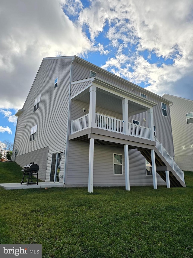 back of house with a lawn