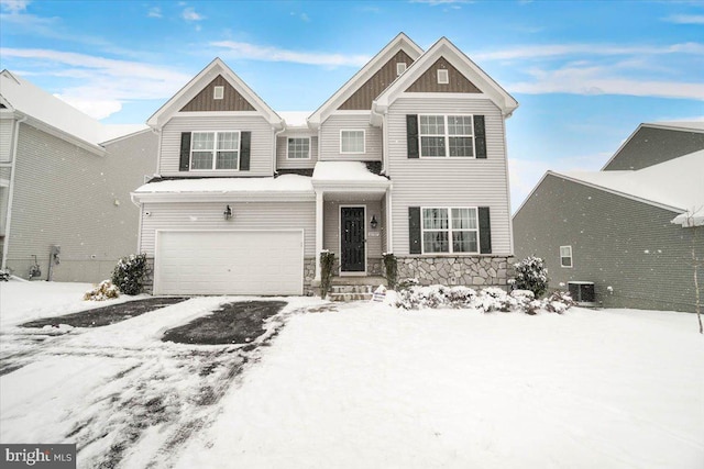 view of front of house with a garage and central AC