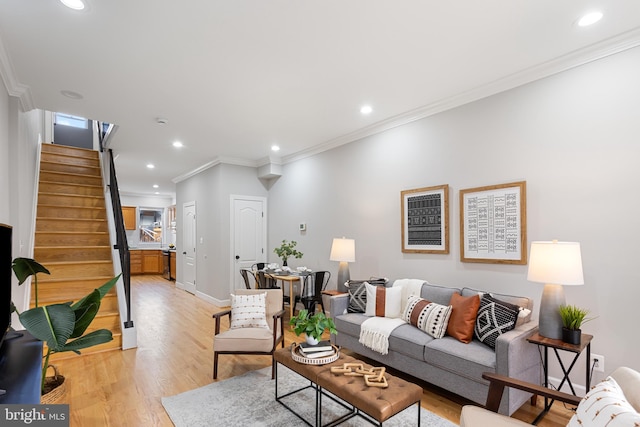 living room featuring crown molding and light wood-type flooring