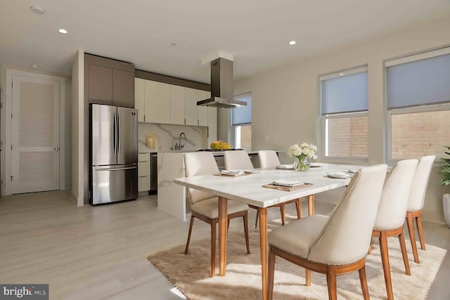 dining room featuring light hardwood / wood-style flooring and sink