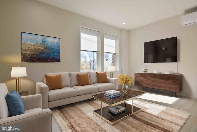 living room featuring light hardwood / wood-style floors and a wall mounted AC