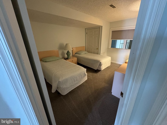 bedroom with carpet and a textured ceiling