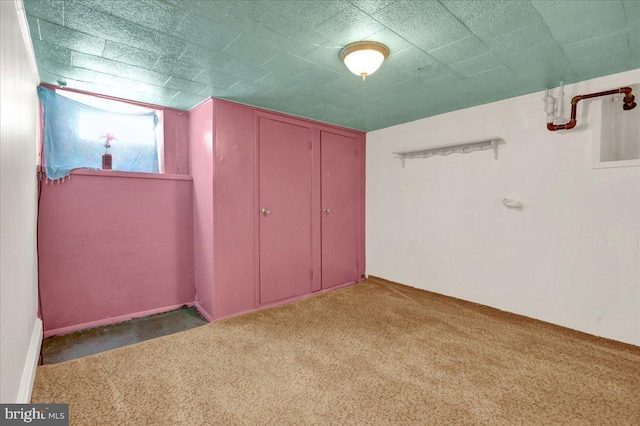 unfurnished bedroom with dark carpet