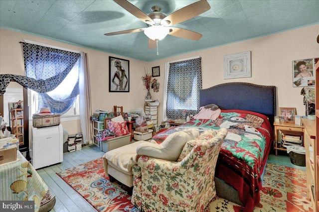 bedroom featuring ceiling fan and light hardwood / wood-style flooring