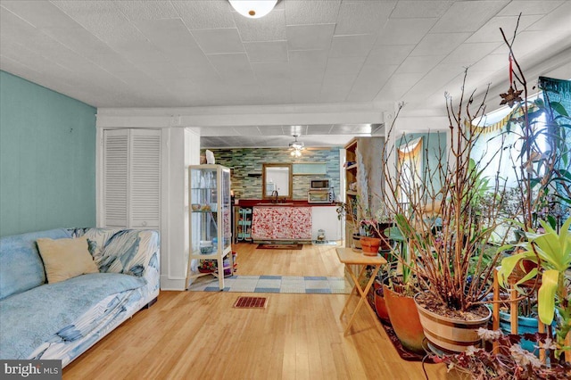 living room with hardwood / wood-style flooring and sink