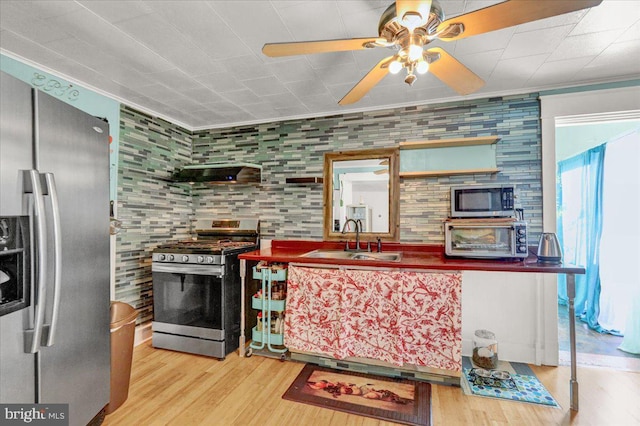 kitchen featuring appliances with stainless steel finishes, hardwood / wood-style floors, range hood, sink, and ornamental molding