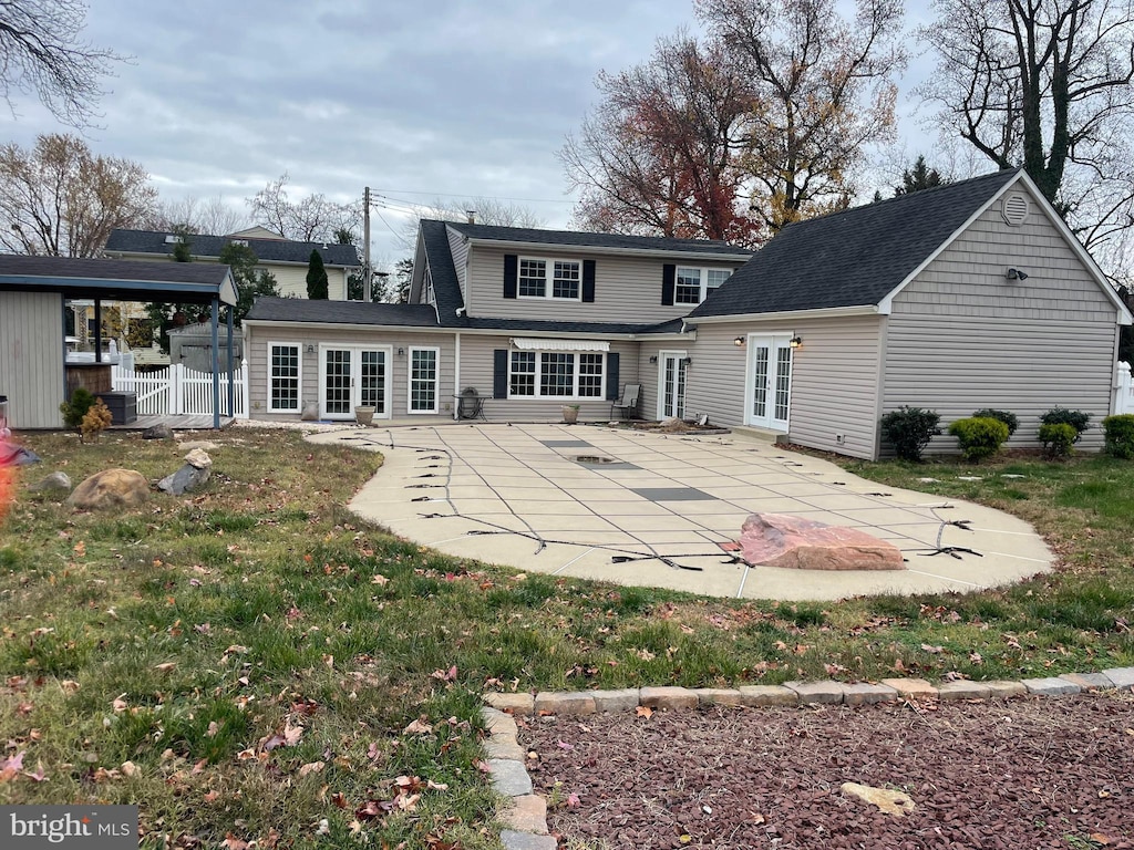 rear view of property featuring a lawn and a patio