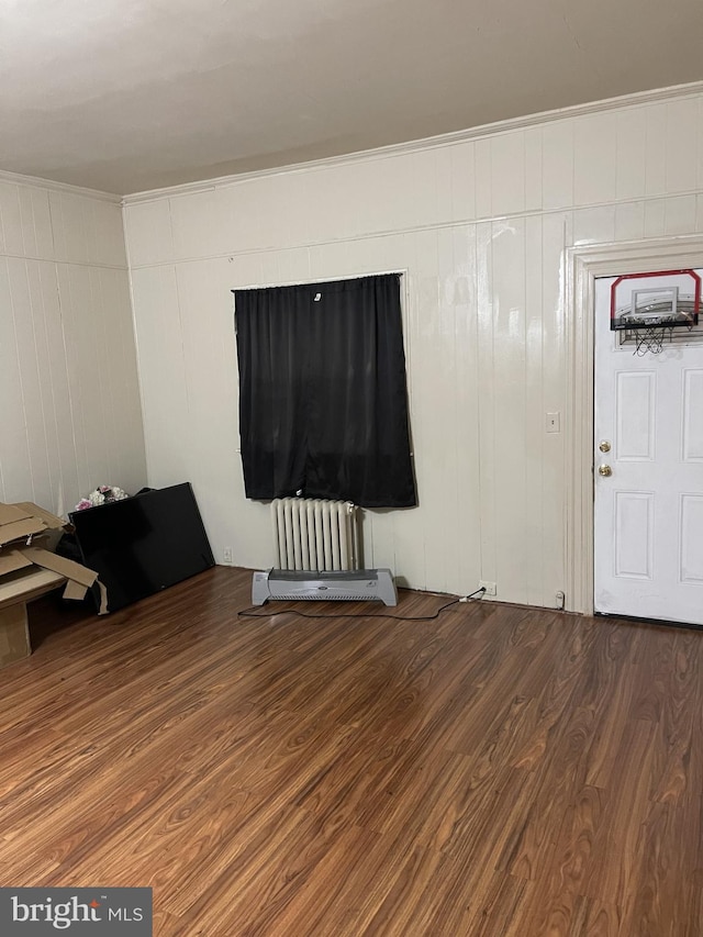 unfurnished room with wood-type flooring and radiator