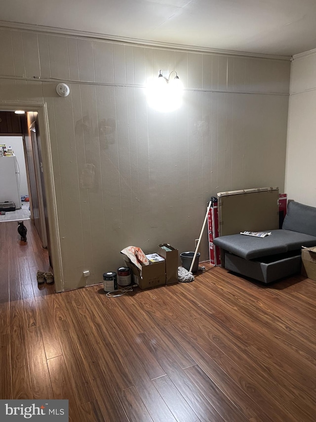 interior space with wood-type flooring and wood walls