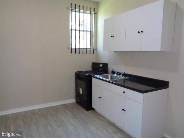 kitchen with white cabinets, sink, black range, and light wood-type flooring