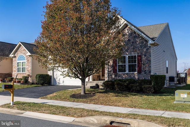 obstructed view of property featuring central AC, a garage, and a front lawn