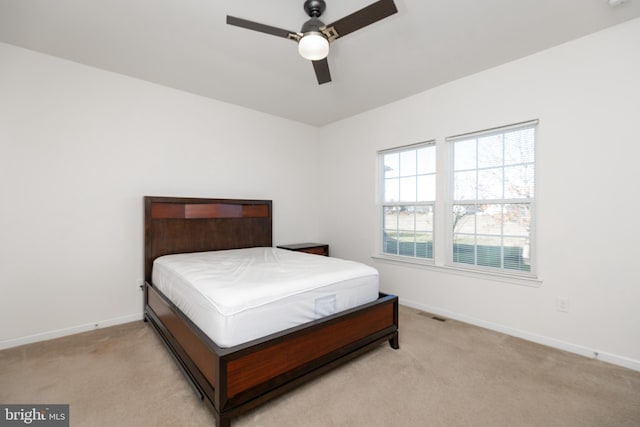 bedroom with light colored carpet and ceiling fan