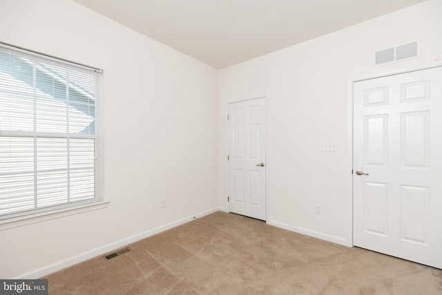 empty room featuring light colored carpet