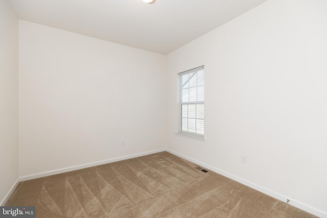 unfurnished room featuring carpet