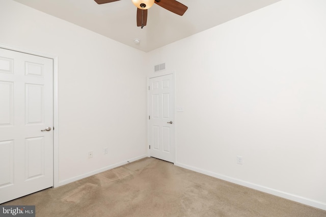 unfurnished bedroom featuring light carpet and ceiling fan