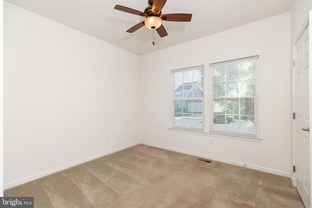 carpeted spare room with ceiling fan