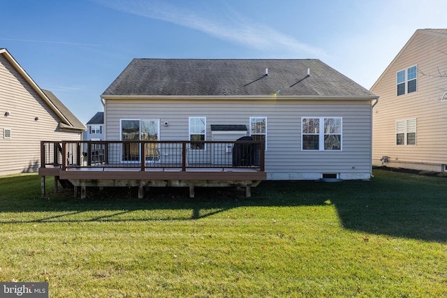 rear view of house with a yard and a deck