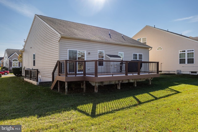 rear view of house with a wooden deck and a yard