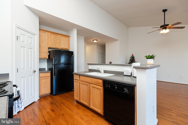 kitchen with light brown cabinets, black appliances, sink, hardwood / wood-style flooring, and ceiling fan