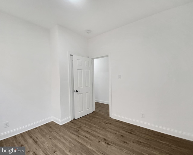 unfurnished room featuring dark hardwood / wood-style floors