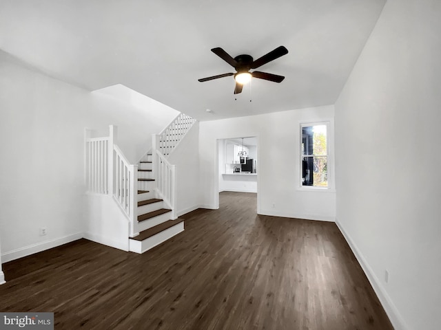 unfurnished living room with ceiling fan and dark hardwood / wood-style flooring