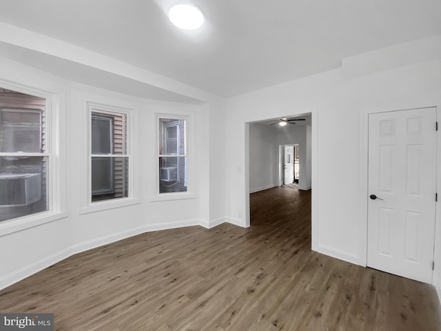 unfurnished room featuring ceiling fan and dark hardwood / wood-style flooring